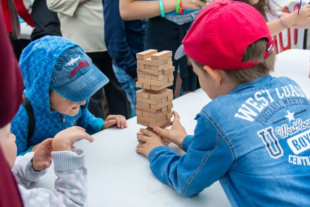 Children play jenga outdoors
