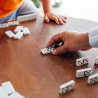 Closeup of senior man playing dominoes with boy