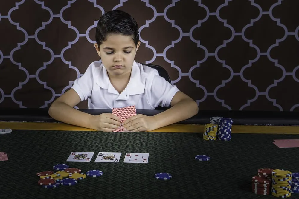 boy sitting at a poker table