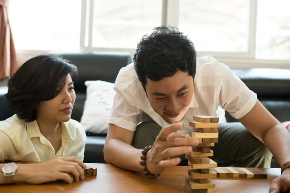 family having fun playing Jenga in the living room