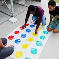 friends play twister game outdoor