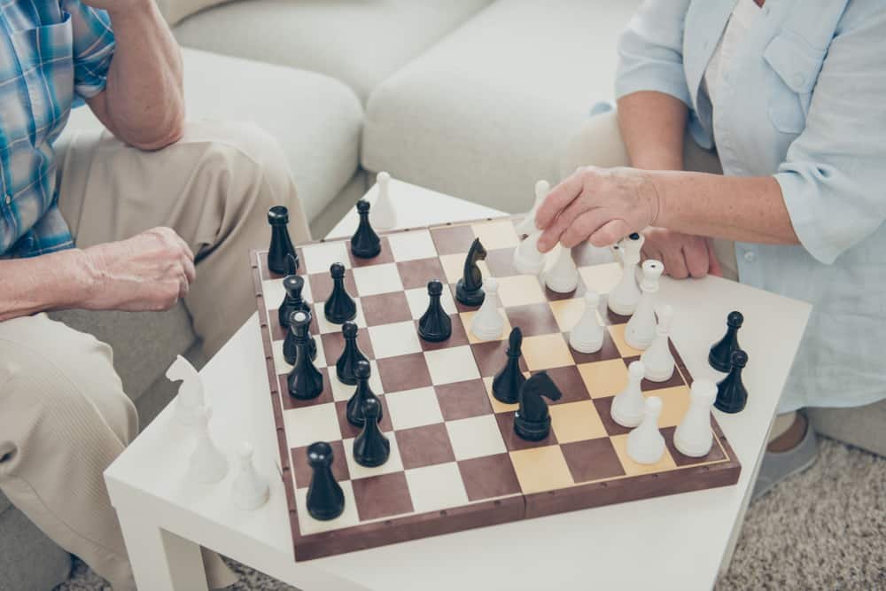 intelligent people playing chess creating move strategy