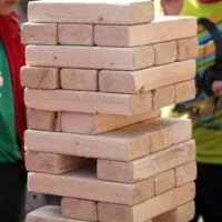 playing in wooden brick game giant jenga