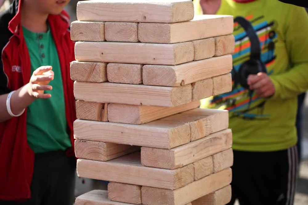 playing in wooden brick game giant jenga