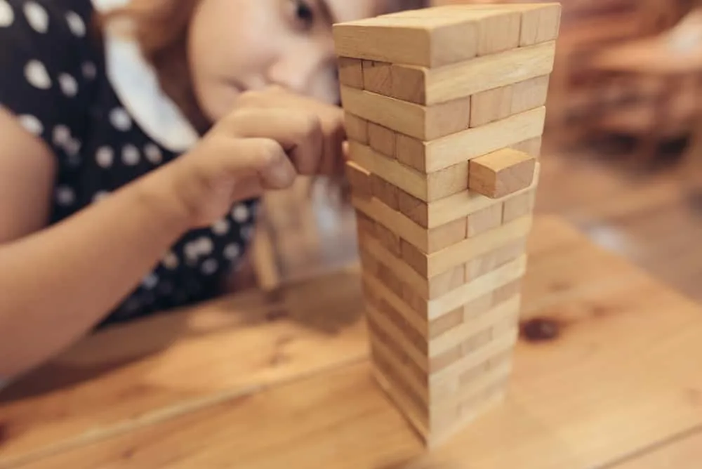 woman having fun playing Jenga at the coffee shop