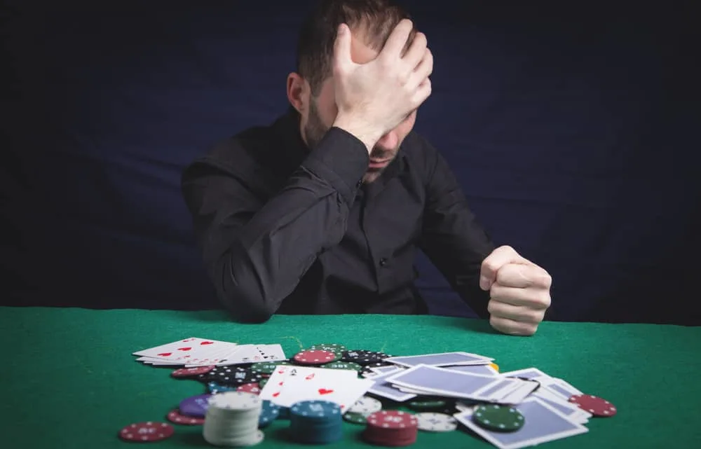 sad man in a casino poker