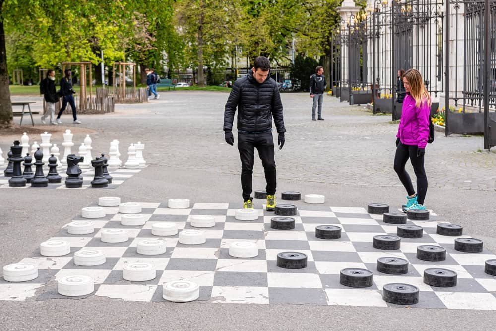  People playing traditional oversized street checkers 
