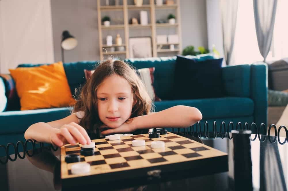 smart girl playing checkers