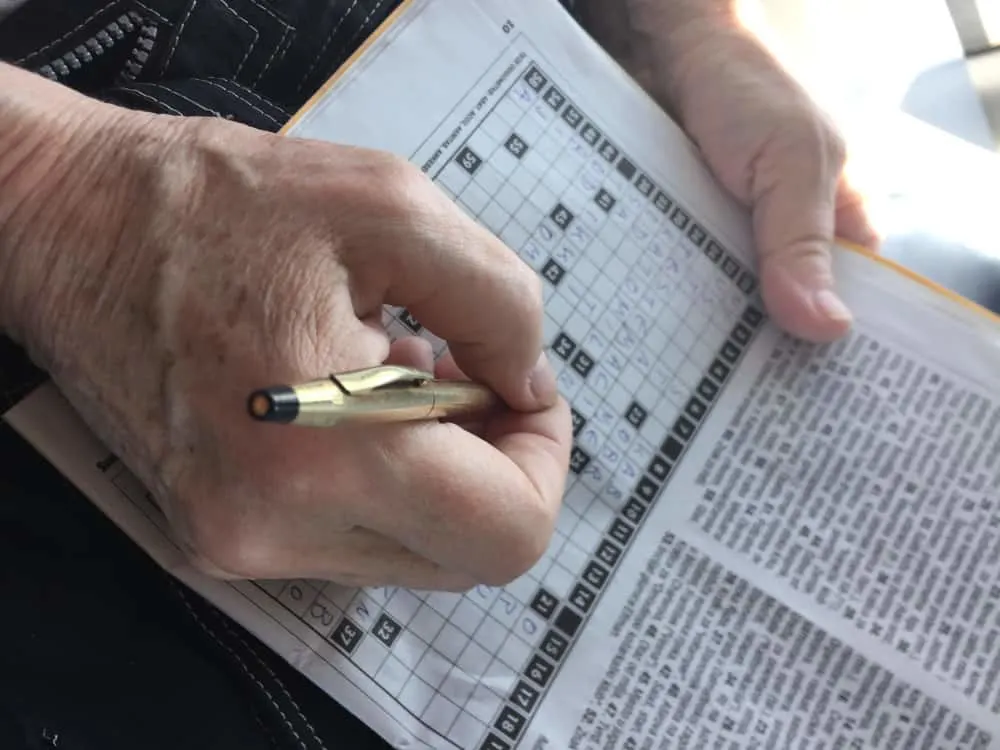 Person doing a crossword puzzle