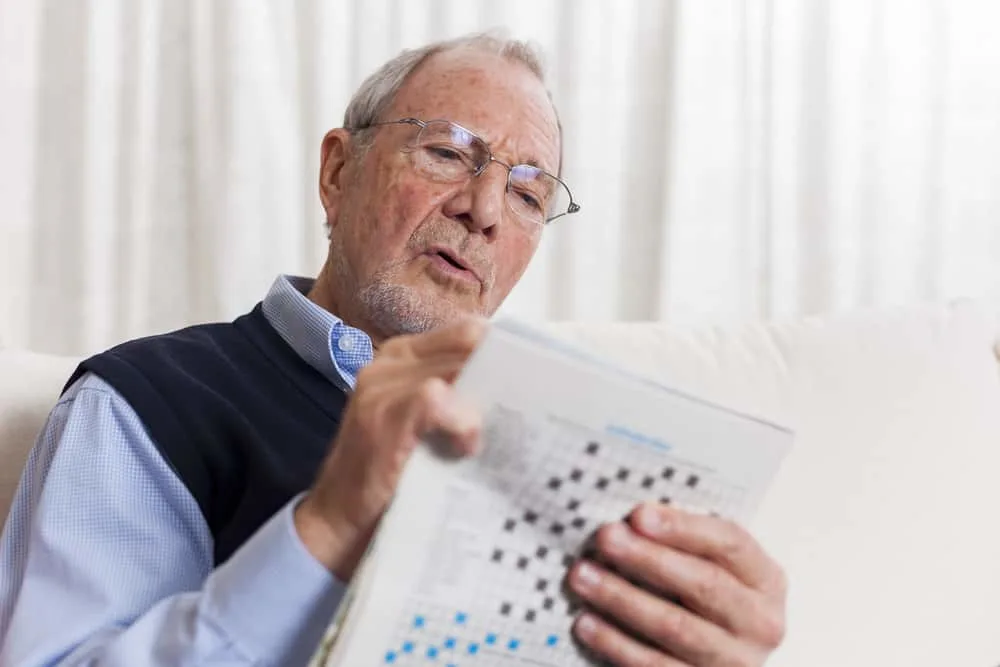 man enjoying retirement doing crossword