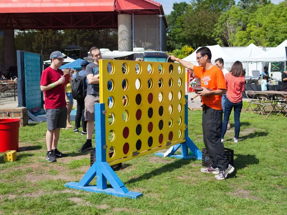 A group of men plays a giant-sized game of Connect Four at the Forks