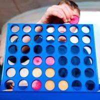 Child playing a traditional strategy game of connect 4