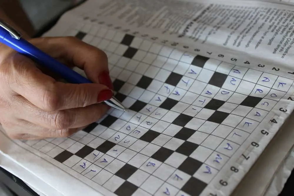 Someone is solving crossword puzzle for fun