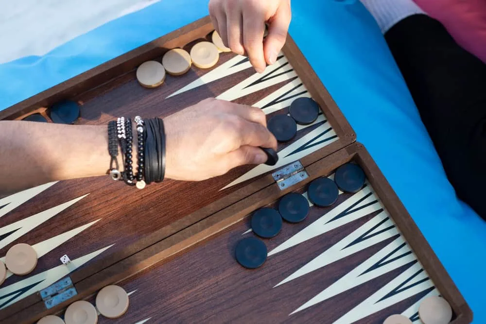 Two friends playing backgammon at home