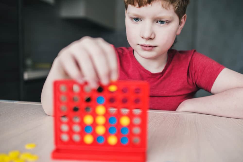 boy playing four in a row