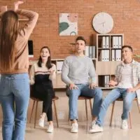 people playing charades in office