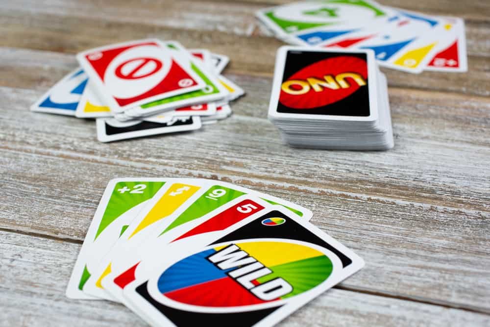 A view of a layout of Uno playing cards on a wooden surface