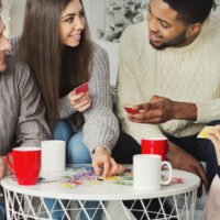 Friends having fun and playing a game of cards, Uno
