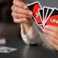 Woman playing Uno cards at home