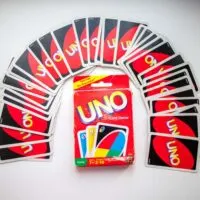 box of Uno card game and cards on white background