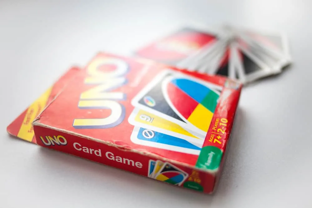 box of Uno card game and cards on white background closeup