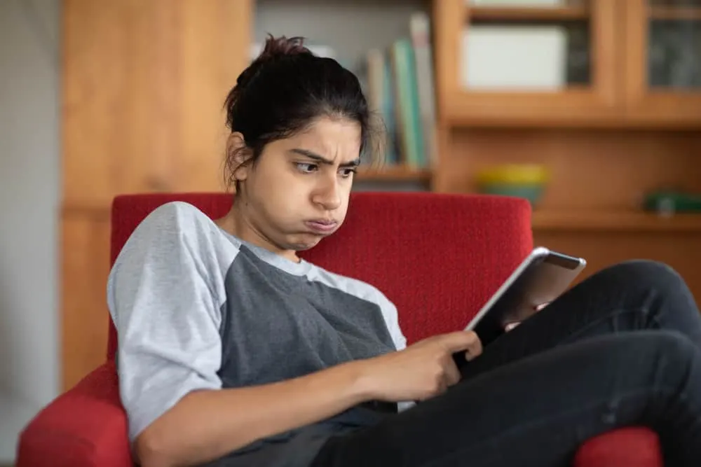 woman frustated, doing a word search puzzle