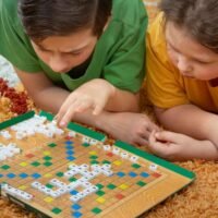 Children play in Scrabble on the floor