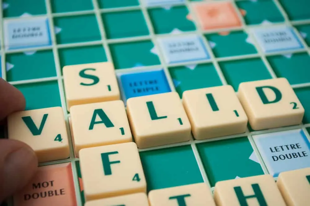 Closeup of plastic letters on Scrabble board game forming the word, Valid