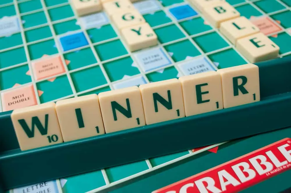 Closeup of plastic letters on Scrabble board game forming the word - winner