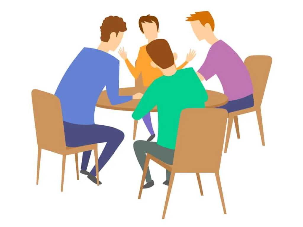 Group of four people sitting down at the table