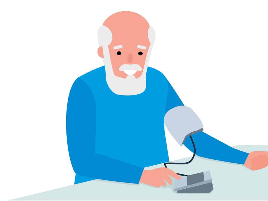 Senior man taking his blood pressure at home