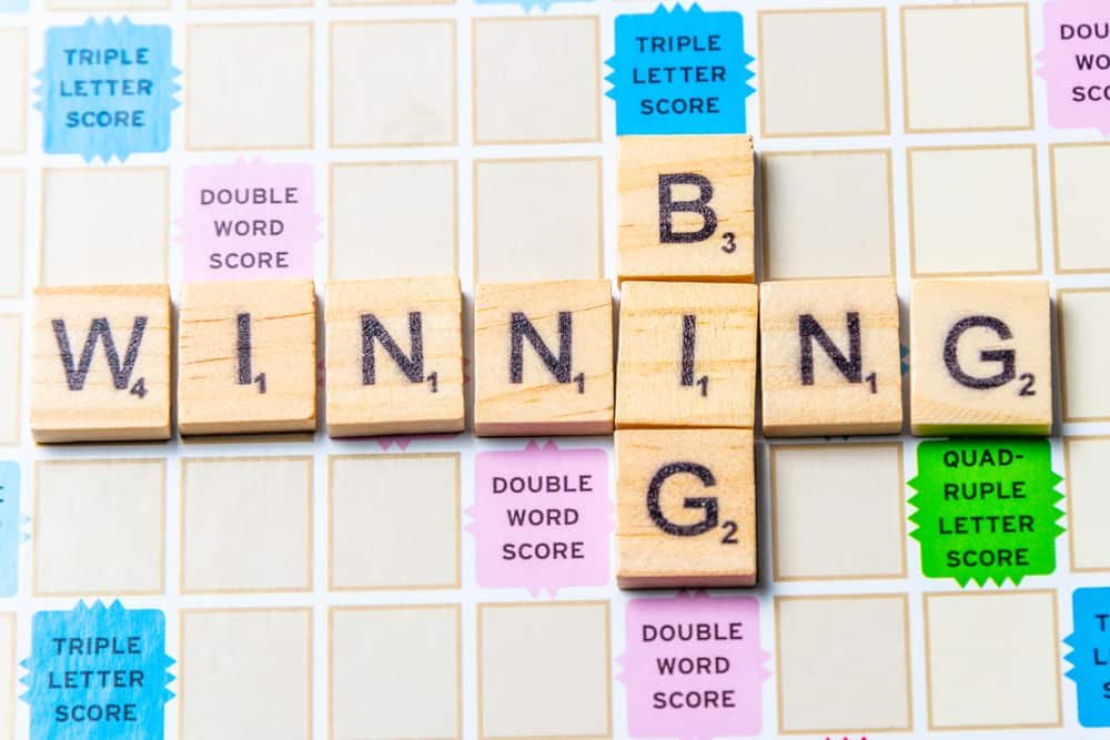 Words BIG and WINNING in scrabble letters over a scrabble board