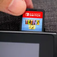 Tetris 99 video game cartridge into the Nintendo Switch