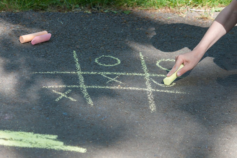 Tic-tac-toe chalk game on asphalt