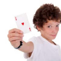 boy showing an ace of hearts