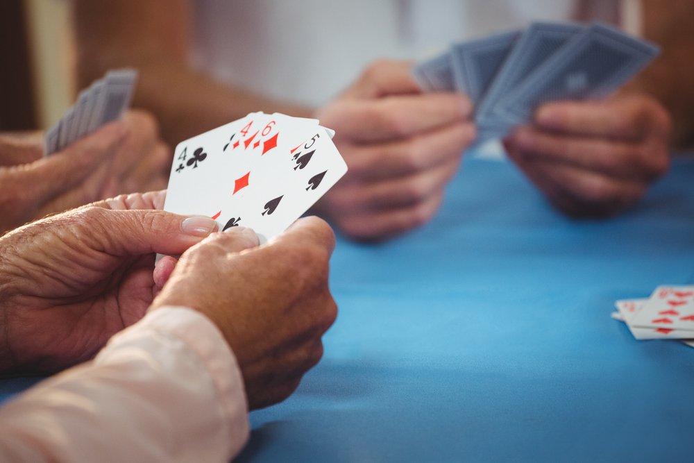 people playing card in a retirement home