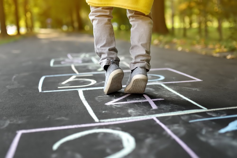 Child playing hopscotch game