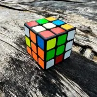 Closeup Rubik's cube on the old wooden vintage background
