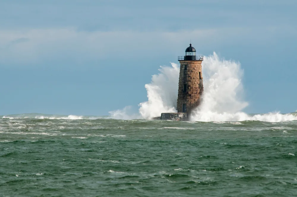 Giant waves cover the stone tower of Whaleback lighthouse