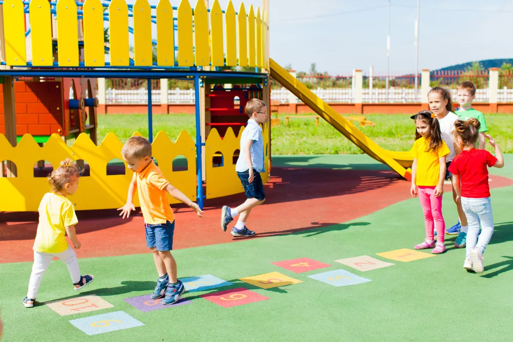 Group of kids play hopscotch on the school