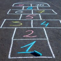 Hopscotch game drawn with chalk on the asphalt