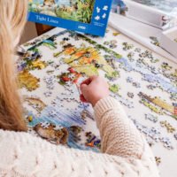 Lady doing a jigsaw puzzle of 1,000 pieces