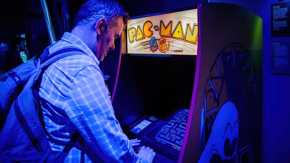  Man playing with pac-man arcade console