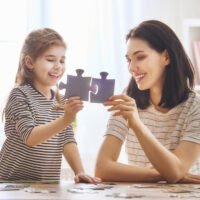 Mother and daughter do puzzles together