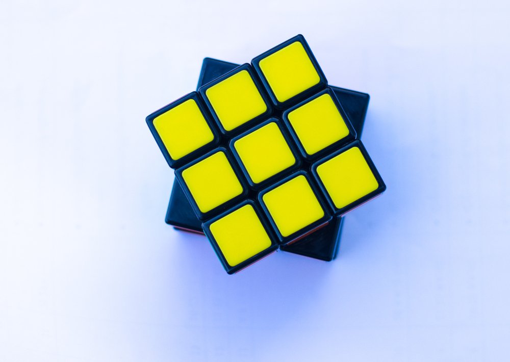 Rubik's cube with shadow on white floor background