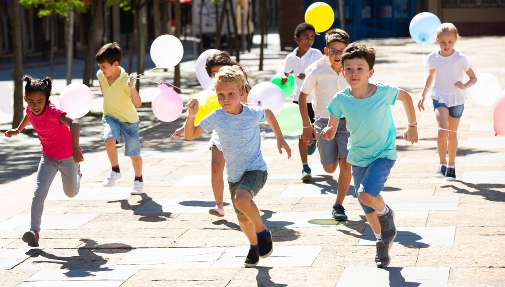 children with balloons running
