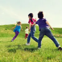 happy kids playing tag game and running