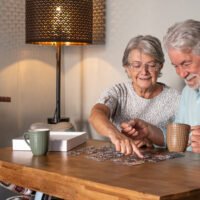 senior couple doing a jigsaw puzzle at home