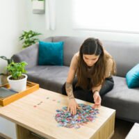 woman putting together a jigsaw puzzle