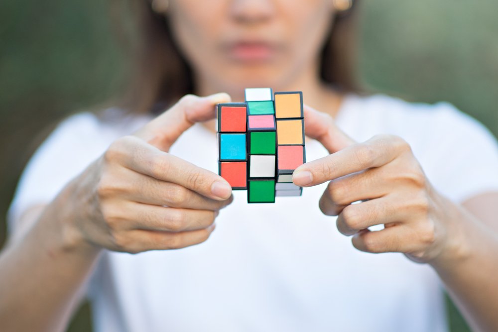 woman wearing casual clothes collect Rubik's Cube